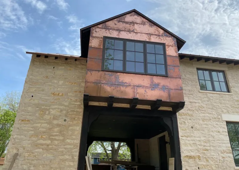 Copper metal panel facade on a stone building for Roof Repair in Citrus Park